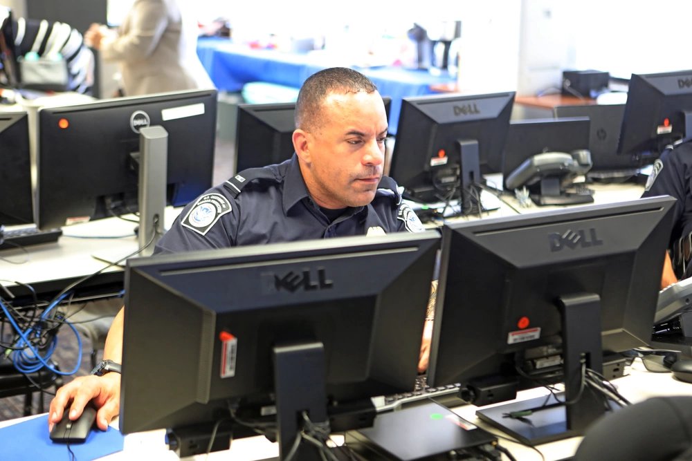CBP officer using multiple monitors