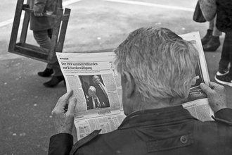 Person reading newspaper
