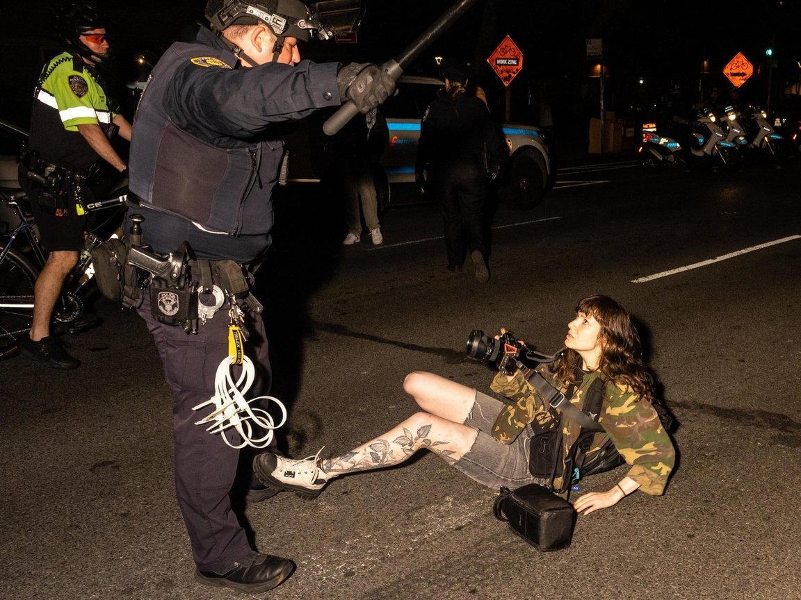 A journalist is knocked to the ground in New York City