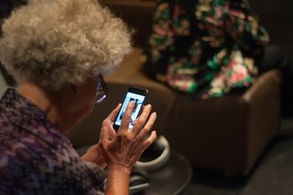 Header image: A woman using a smartphone.