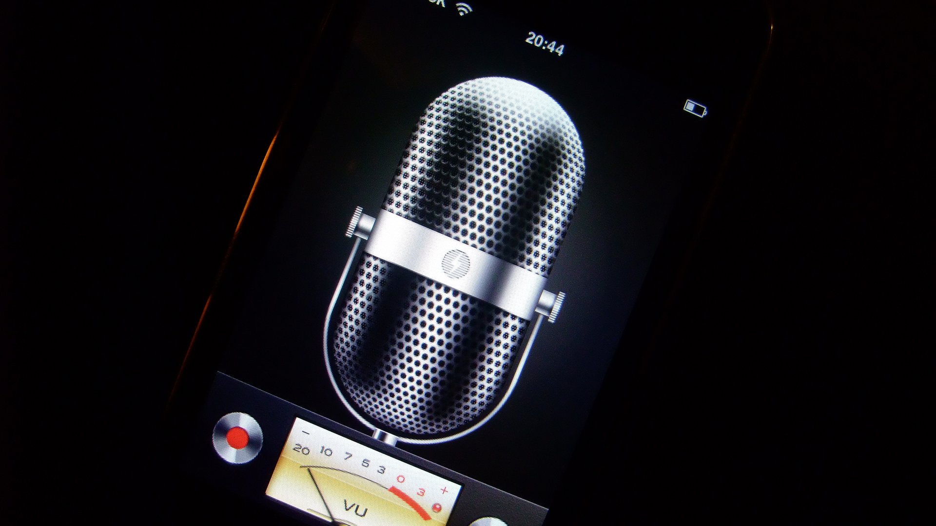 Photo of a cellphone showing a voice recording application with a microphone and audio dials