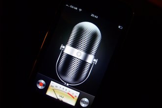 Photo of a cellphone showing a voice recording application with a microphone and audio dials