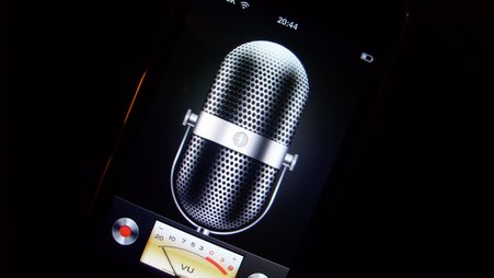 Photo of a cellphone showing a voice recording application with a microphone and audio dials