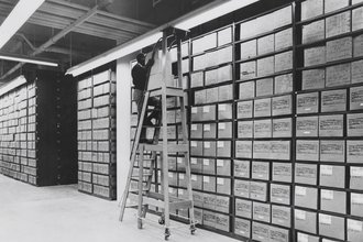 An archivist at work in the stacks.
