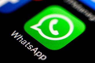 A WhatsApp logo button on a phone homescreen