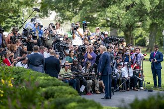 Then-President Donald Trump speaks with reporters on the South Lawn of the White House in August 2019.