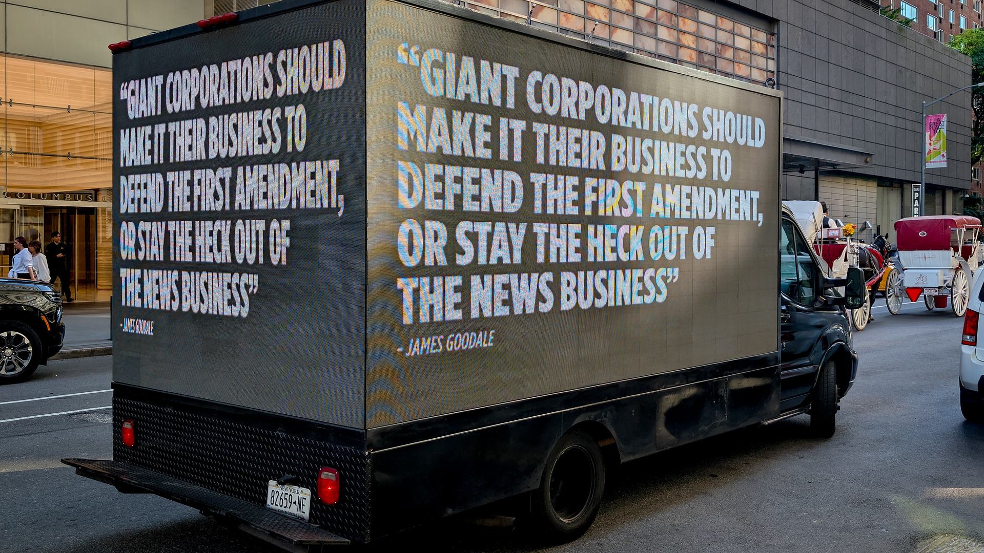 A mobile billboard quoting legendary First Amendment lawyer James Goodale during an April protest in New York against the Paramount-Warner Bros. merger. The billboard reads “Giant corporations should make it their business to defend the First Amendment, or stay the heck out of the news business.”