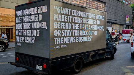 A mobile billboard quoting legendary First Amendment lawyer James Goodale during an April protest in New York against the Paramount-Warner Bros. merger. The billboard reads “Giant corporations should make it their business to defend the First Amendment, or stay the heck out of the news business.”