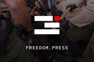 The FPF logo and website URL freedom.press overlaid on top of a dramatic photo of a law enforcement and journalist scuffle.