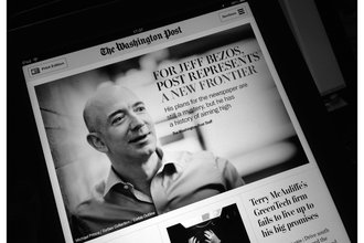 The front page of The Washington Post with a picture of Jeff Bezos and the headline and subtitle "For Jeff Bezos, Post Represents a New Frontier: His plans for the newspaper are still a mystery, but he has a history of aiming high"