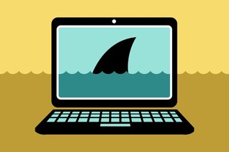 A picture of a laptop with a shark fin rising above water on the screen