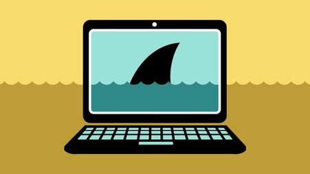 A picture of a laptop with a shark fin rising above water on the screen