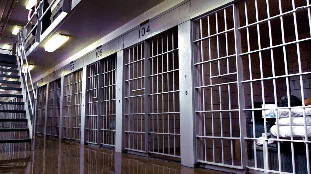 An incarcerated person watches television in his prison cell in Illinois.