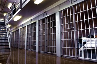 An incarcerated person watches television in his prison cell in Illinois.