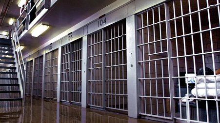An incarcerated person watches television in his prison cell in Illinois.