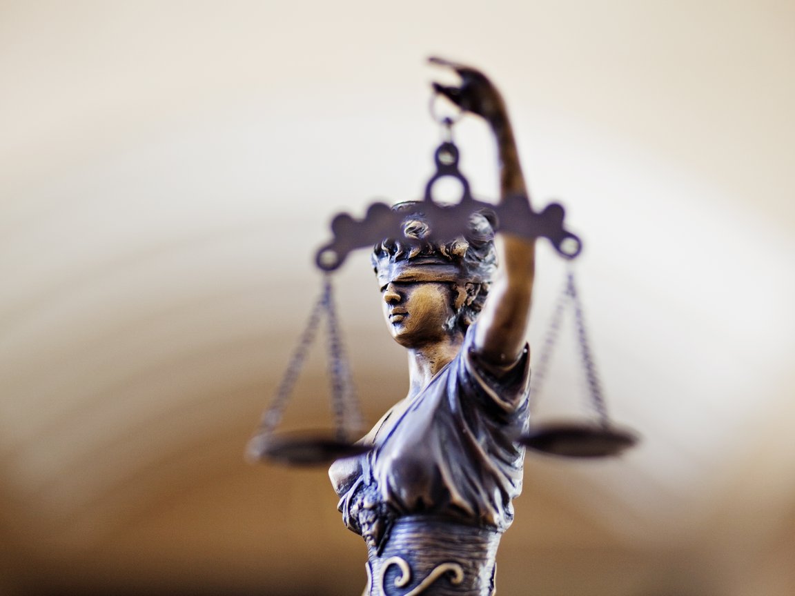 Blindfolded Lady Justice and the scales of justice