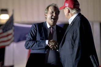 Donald Trump shakes hands with Texas Attorney General Ken Paxton at a rally, Oct. 22, 2022, in Robstown, Texas