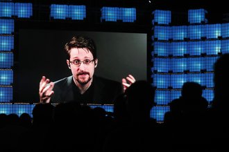 Edward Snowden speaks to an audience via video conference.