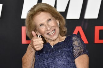A photo of Shari Redstone, Paramount Global chair, giving a thumbs-up at a movie premiere.