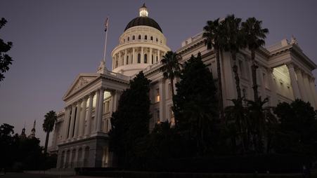 The California state capitol in Sacramento at night, with some lights visible in the windows
