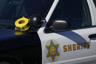 A roll of police tape is left on the windshield of a Los Angeles County sheriff's vehicle in the parking lot of its training academy in Whittier, Calif., Nov. 16, 2022