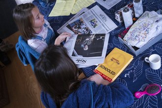 Children in Maryland read a newspaper before school.
