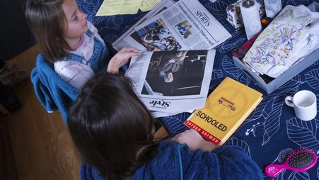 Children in Maryland read a newspaper before school.