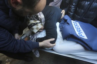 A relative mourns Palestinian journalist Akram Al-Shafi'i in January, after he was killed in an Israeli bombardment of the Gaza strip.