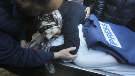 A relative mourns Palestinian journalist Akram Al-Shafi'i in January, after he was killed in an Israeli bombardment of the Gaza strip.