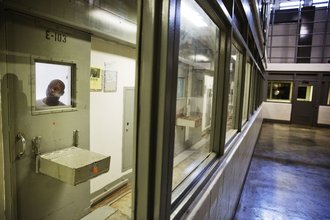 An incarcerated person looks out of his cell at a maximum security prison in Georgia.