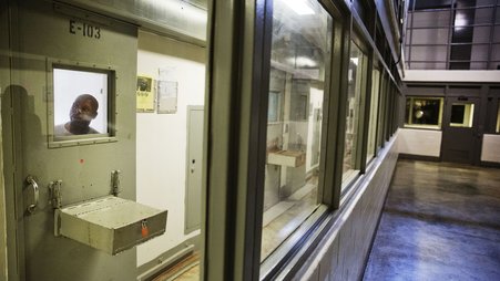 An incarcerated person looks out of his cell at a maximum security prison in Georgia.