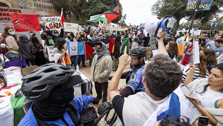 Pro-Palestinian demonstrators and pro-Israel demonstrators clash at the University of California, Los Angeles on April 25, 2024.
