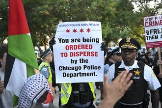 Police disperse both protesters and journalists at a demonstration during the Democratic National Convention on Aug. 19, 2024, in Chicago.