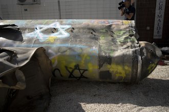Iranian ballistic missile components that were fired at Israel are displayed during a government-organized media tour on a base in southern Israel.
