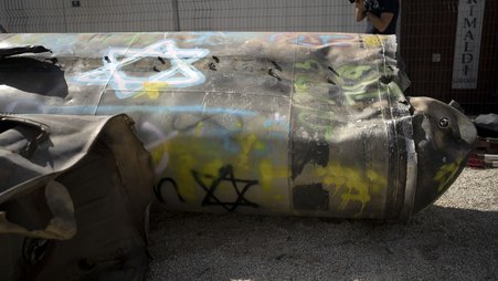 Iranian ballistic missile components that were fired at Israel are displayed during a government-organized media tour on a base in southern Israel.