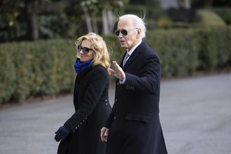 President Joe Biden waves to journalists as he walks alongside First Lady Jill Biden while arriving at the White House Jan. 2, 2025