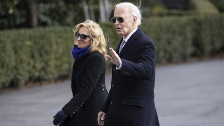 President Joe Biden waves to journalists as he walks alongside First Lady Jill Biden while arriving at the White House Jan. 2, 2025
