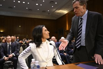 Democratic Sen. Mark Warner greets Director of National Intelligence nominee Tulsi Gabbard at her Jan. 30 confirmation hearing.
