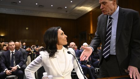 Democratic Sen. Mark Warner greets Director of National Intelligence nominee Tulsi Gabbard at her Jan. 30 confirmation hearing.