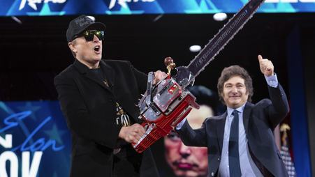 Elon Musk holds a chainsaw at the Conservative Political Action Conference on Feb. 20, 2025.