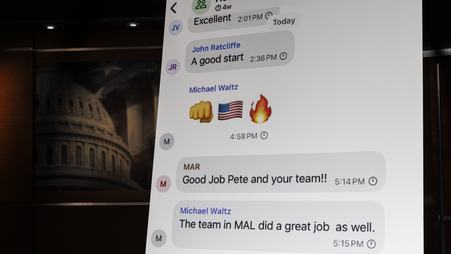 A poster of a Signal group chat between Trump administration officials, shown during a House Democratic press conference.