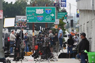 Media crews covering protests against ICE, U.S. Immigration and Customs Enforcement, operations, gather along a sidewalk Tuesday, June 10, 2025, in downtown Los Angeles.