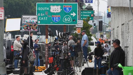 Media crews covering protests against ICE, U.S. Immigration and Customs Enforcement, operations, gather along a sidewalk Tuesday, June 10, 2025, in downtown Los Angeles.