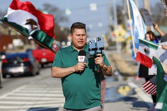 Mario Guevara covers a protest against immigration enforcement in Georgia in February 2025.