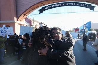 Baltazar Enriquez, president of the Little Village Community Council, hugs a community member at a Chicago Public School's student walkout protesting ICE agents around Chicago's Little Village neighborhood, Oct. 29, 2025.