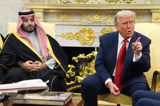 The Saudi Crown Prince sits on the left while Donald Trump sits on the right, pointing with his index finger and emoting to the audience.