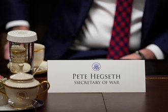 A close up of a name card on a table that reads "Pete Hegseth" and "SSecretary of War" with "secretary" misspelled with two s's