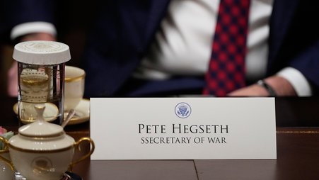 A close up of a name card on a table that reads "Pete Hegseth" and "SSecretary of War" with "secretary" misspelled with two s's