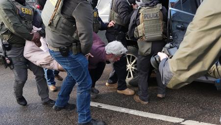 ICE agents arrest a protestor in Minneapolis