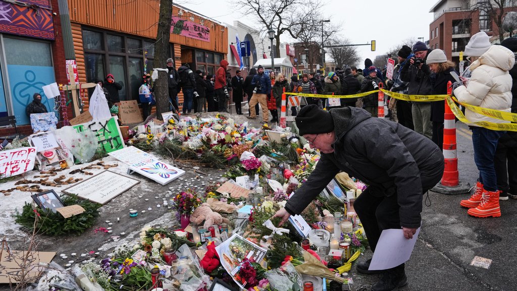 People visit a makeshift memorial for Alex Pretti on Jan. 26, 2026, in Minneapolis.